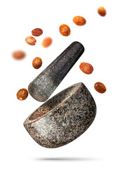 Granite mortar and muscat nut falling isolated on white background