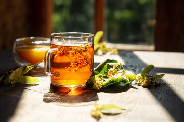 Hot linden blossom drink, honey and flowering branch