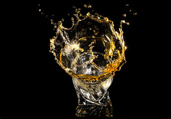 A glass of whiskey with splashes from the ice cube over black background. alcohol splashes. whisky or cognac or another type of alcohol with splashes.