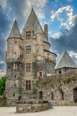 Fototapeta na wymiar Medieval castle of Vitre city in Brittany (France). View of towers and main entrance gatehouse and facade of the medieval castle Chateau.
