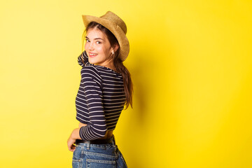 Portrait hipster beauty girl in hat on yellow background