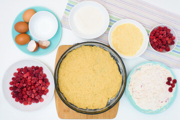 Fototapeta na wymiar step by step cooking process and ingredients for homemade raspberry pie - egg, cottage cheese, flour, raspberries, sugar, dough, baking dish, butter. top view on a light background
