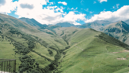 Obraz premium Panorama of beautiful springtime green hills of the mountain and the road