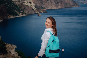 Woman above cold sea on cliff alone. Travel Lifestyle concept