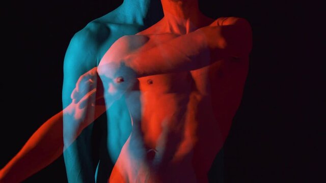 Overlaying of two male naked bodies. One red body dancing and one blue body moving slowly.