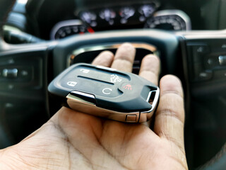 a driver is carrying a modern key of a car