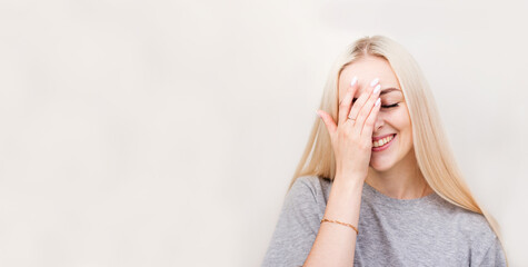 So dumb but so sweet. Studio shot of attractive stylish woman making facepalm, holding hand on eyes...