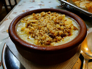 Traditional Turkish family sweet dessert, rice pudding, in a local restaurant in Safranbolu in Turkey. Made of rice mixed with sugar, salt, and milk. Decorated by nuts.