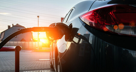Pumping gas fuel car at oil station. Woman hand refuel petrol nozzle tank. Refueling transportation...