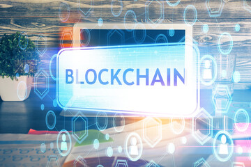 Multi exposure of blockchain theme hologram and table with computer background. Concept of bitcoin...