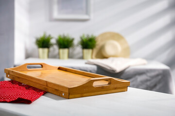A white wooden table in a room with a free space for an advertising product