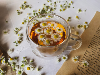 a cup of chamomile tea on an old table