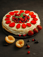 Pancakes with berries, dessert for breakfast on a black background. Copy space for text