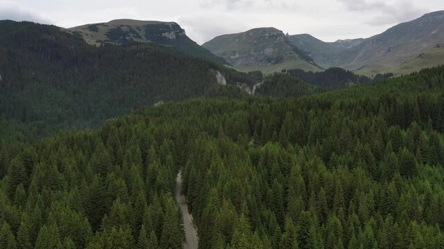 Drone 4k clip with car traveling on the Trans Bucegi mountain road high up in the Carpathian Mountains.