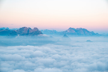 Swiss alpine peaks in clouds during beautiful sunrise