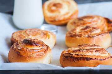 Homemade yeasty buns with cottage cheese filling with milk.