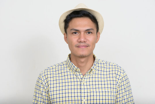 Portrait of handsome Asian tourist man wearing hat
