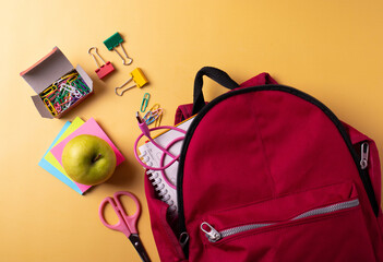 school dark red backpack and stationary items