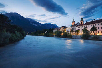 Fototapeta premium Photograph of the river Eno at night, with the Tyrol in the background. Innsbruck, Austria.