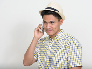 Portrait of handsome Asian tourist man talking on the phone