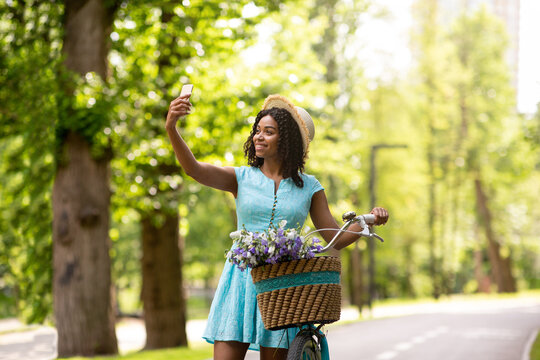 Lovely Black Girl Taking Selfie On Bike Ride At Sunny Summer Park