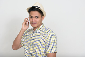 Portrait of handsome Asian tourist man talking on the phone
