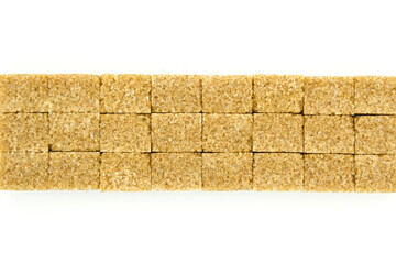 Line of brown sugar cubes on isolated on white background. Copy space for text.