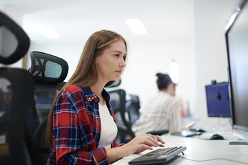 casual business woman working on desktop computer