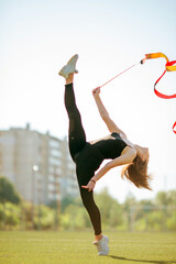 girl in black sport outfit doing doing gymnastics handstand in the splits © Bogdan