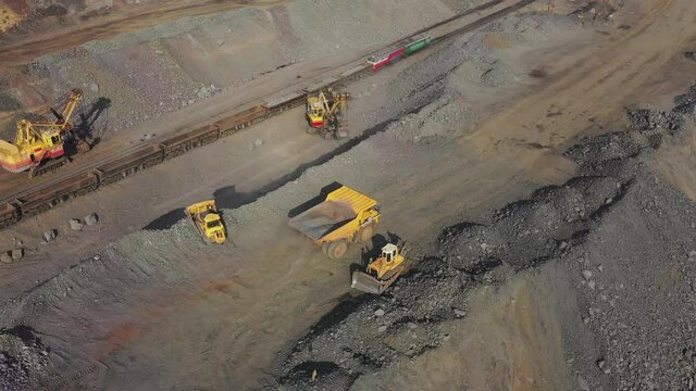 Heavy mining machinery in a quarry for the extraction of limestone, industrial aerial view panorama.