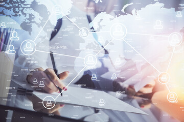 Social network theme hologram over hands taking notes background. Concept of global international people connect. Double exposure