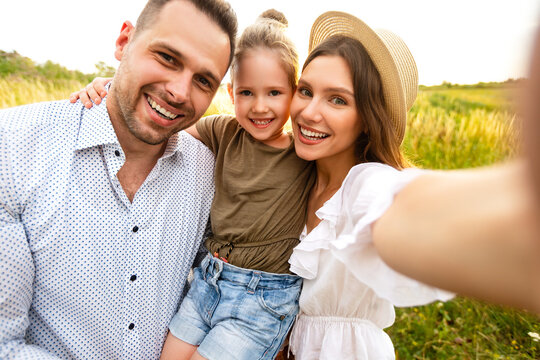 Happy loving family taking selfie on a picnic outdoor