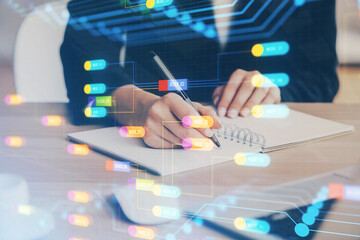 Double exposure of writing hands on background with data solution hologram on front. Technology concept. Close up