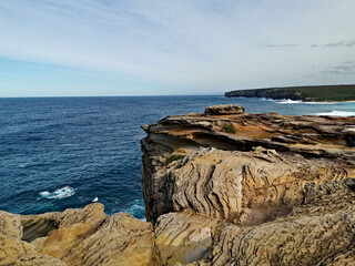 Fototapeta premium Beautiful and colorful rock formations along the sea cliff, Royal National Park, Sydney, New South Wales, Australia