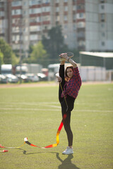 girl in black sport outfit doing doing gymnastics handstand in the splits © Bogdan