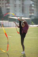 girl in black sport outfit doing doing gymnastics handstand in the splits © Bogdan
