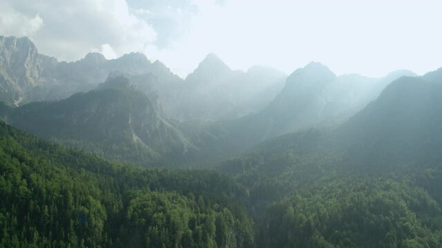 4K Sun Flared Drone Push Back Shot Of Mountains And Forest