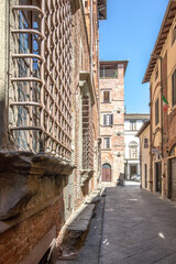 Fototapeta na wymiar Street of Lucca in Italay, Tuscany. Hot summer day in an italian city with medieval architecture.