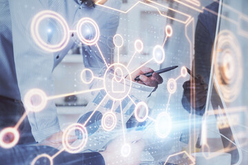 Social network theme hologram with businessman working on computer on background. Multi exposure.