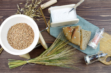 A small grain grinder on a wooden background. Traditional wheat and grain grinder used to grind grain and make flour of wheat and rice. Czech Republic, Europe.
