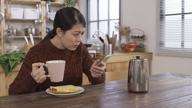 asian lady with phone taken aback by news about confirmed cases of covid-19 in European countries increasing steeply. korean woman chewing astonished to see death toll of coronavirus rising rapidly