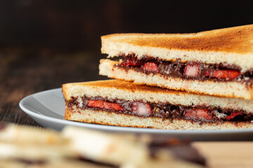 Sandwich toast with chocolate paste and cut strawberry