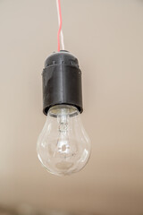 Old tungsten light bulb on gray background