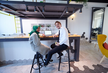 international multicultural business team working together on laptop