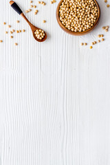 top view pile of soybeans in bowl on white table top view copy space