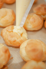 Homemade the process of preparation Eclairs a lot of with cream injector.