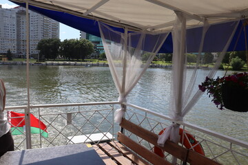 boats deck with vase of flowers and incredible lake view