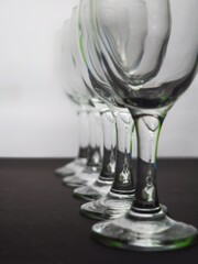 Row of empty wine glasses on table. Black and white concept