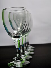 Row of empty wine glasses on table. Black and white concept