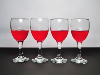 Red liquid in glass. Soft drink